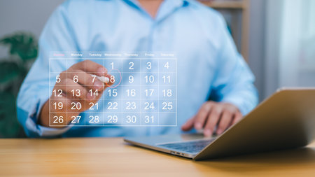 Person using a digital calendar on a laptop, symbolizing effective time management, business planning, and deadline tracking. Ideal for productivity, organization, corporate agenda, and event planningの写真素材