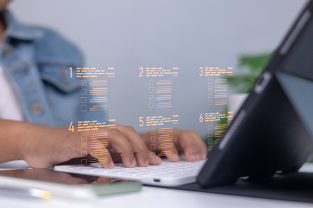 Person using a digital checklist on virtual screen while typing on keyboard, representing productivity, task management, and modern office workflow with technology.の写真素材