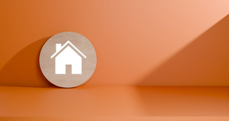 3D render featuring a clean white house icon on a round wooden coin. a vibrant orange wall and a floor with natural light and shadows. Real estate, home security, and housing concepts.の写真素材