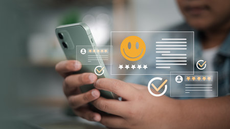 Customer using smartphone with holographic online review, star rating, and user feedback icons, representing customer experience, satisfaction, and digital business engagement.の写真素材