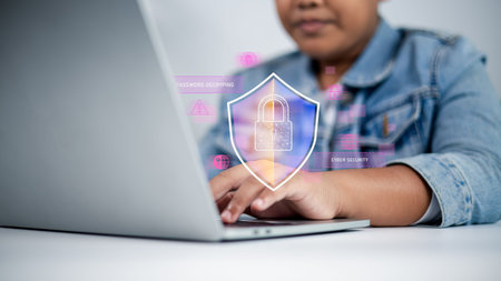 Business hand typing on laptop with digital shield icon and lock symbol representing cyber security,...