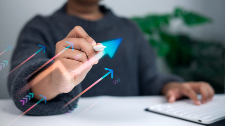 Business hand using digital pen drawing rising arrows on virtual screen symbolizing growth, progress, success, and financial achievement in modern business concept.の写真素材