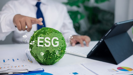 Business professional analyzing ESG strategy with green digital globe, sustainability icons, environmental responsibility, corporate governance concept for eco friendly business and investment growth.の写真素材