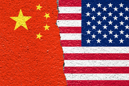 China and United States flags painted on cracked wall. Concept of trade war, political tension, and conflict in global business and international relations.の写真素材