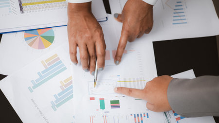 Business team analyzing financial charts and data reports during meeting. Concept of strategy planning, finance management, and business analytics for corporate success.の写真素材