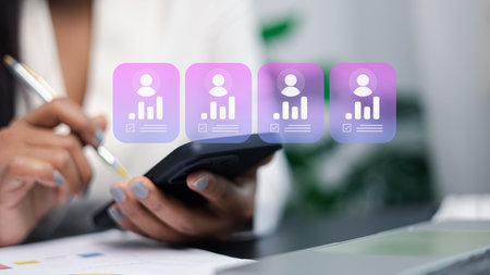 Close-up of hands using smartphone with floating user profile analytics icons, representing data management, digital dashboard, productivity tools, mobile workflow and modern business technology.の写真素材