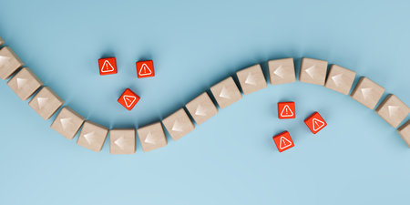 Overhead view of wooden block cubes arranged in a flowing wave pattern, disrupted by small red cubes featuring warning (exclamation mark) icons, symbolizing business risk and problems.の写真素材
