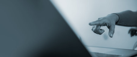 Business person hand pointing at laptop screen with copy space, focused on digital choice, selecting...