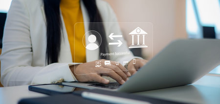 Businesswoman using laptop for online banking and money transfer with virtual holographic interface...
