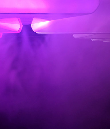 Background abstract purple with neon glow, lights, glowing lines and smoke. Pink blue, ultraviolet spectrum, laser show, fogの写真素材