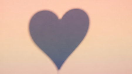 A blurry heart shape is centered on a gradient background transitioning from pink to blue to peach, creating a soft and romantic visual effect, similar to another in the collection. Clear details and vibrant colors enhance visual appeal.の素材
