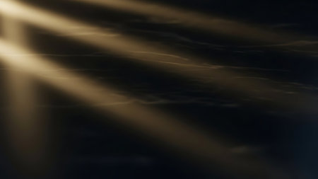 A dark background illuminated by golden light rays that shine and glow with a radiant effect, creating a sense of illumination and texture. Clear details and vibrant colors enhance visual appeal. resolution use.の素材