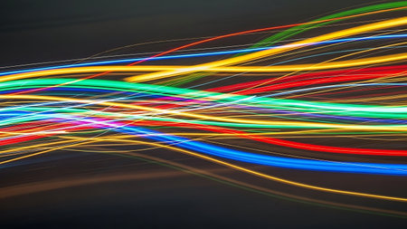 A dark background with vibrant, multicolored neon light trails streaking across it, conveying a sense of motion and energy. Clear details and vibrant colors enhance visual appeal. resolution use.の素材