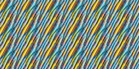 Multicolored plastic wire on a blue background. Close-up.