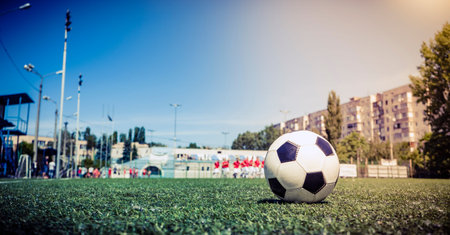 Soccer ball on grass in soccer stadium.