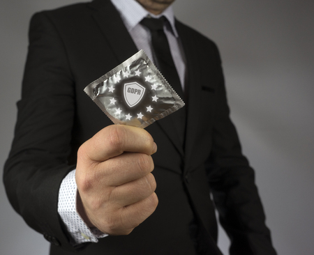 GDPR. Data Protection Regulation. Cyber ??security and privacy. Businessman holding a condom a shield with a lock symbol (GDPR)の写真素材