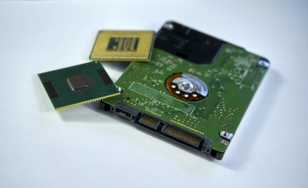 2,5 inch laptop sata hard drive with two CPU laptop processors isolated on white background with clipping pathの写真素材