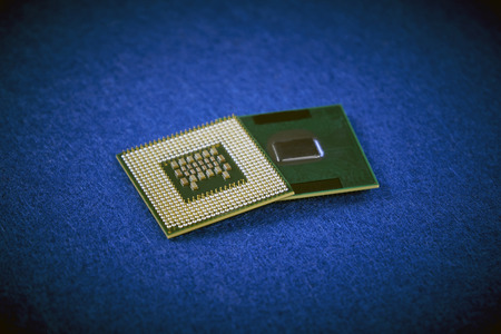 Two different CPUs showing different types of connections on blue backgroundの写真素材