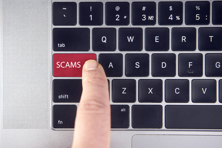 Laptop keyboard button with word scam alertの写真素材