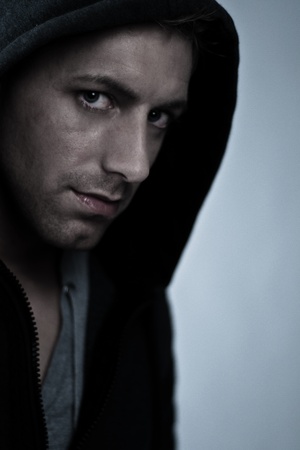 young man with intensive eyes wearing a hood の写真素材