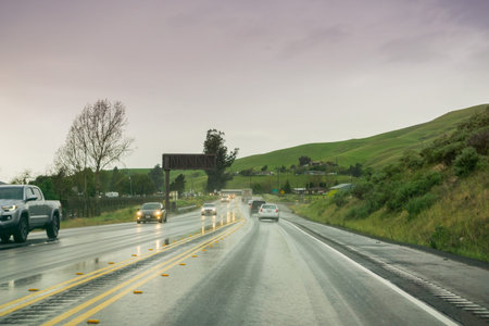 Driving through rain on a wet road, California