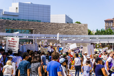 June 30, 2018 San Jose / CA / USA - Crowds carrying banners gathered for the "Families belong together" rally held in front of the City Hall, in downtown San Joseのeditorial素材