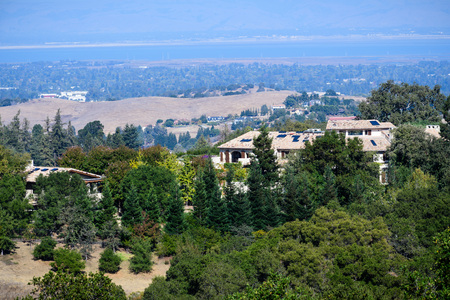 Mansions on the hills surrounding San Francisco bay area; the bay shoreline visible in the backgroundの写真素材