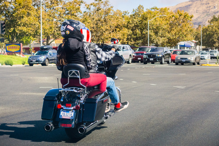 October 6, 2018 Milpitas / CA / USA - Couple riding on a motorcycle wearing helmets with the american flag and mapのeditorial素材
