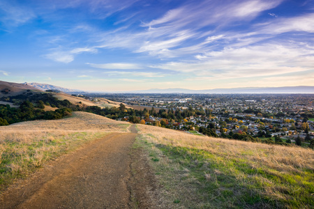 Hiking trail in the evening in Garin Dry Creek Pioneer Regional Park, Fremont and south San Francisco bay in the background, Californiaの写真素材