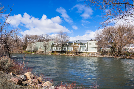 Apartment complex on the shoreline of Truckee River, Reno, Nevada; increased water level due to snow meltの写真素材