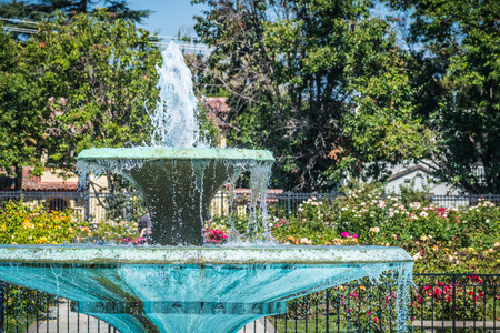 Water fountain surrounded by beautiful blooming roses, the Municipal Rose Garden, San Jose, south San Francisco bay area, Californiaの写真素材