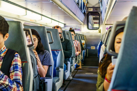 August 21, 2018 San Francisco / CA / USA - People looking at their phone while riding in a Caltrain (local train going through Silicon Valley), south San Francisco bay areaのeditorial素材