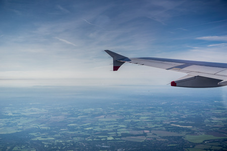 Flying over green fields in the British countryside, close to London, United Kingdomの写真素材