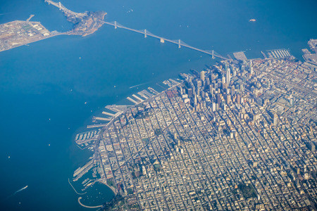 San Francisco financial district and the Bay Bridge as seen from an airplane on a clear sunny dayの写真素材