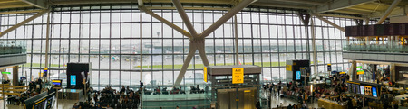 September 9, 2017 London/UK - Panoramic view of Heathrow airport Terminal 5 lounge area and tall windows on a rainy dayのeditorial素材