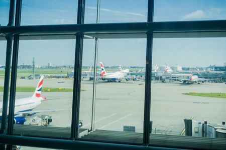 September 24, 2017 London/UK - Looking through the large windows of Terminal 5 to the airplanes stationed outside, Heathrow airportのeditorial素材