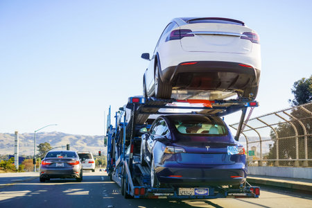 December 2, 2018 Gilroy / CA / USA - Car transporter carries Tesla Model 3 new vehicles along the...