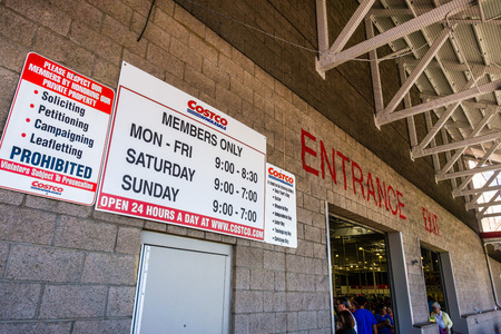 August 6, 2018 Mountain View / CA / USA - Entrance / Exit to one of the Costco Wholesale supermarkets in south San Francisco bay area; stores hours displayed on the wallのeditorial素材