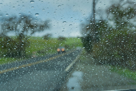 Raindrops on the windshield while driving on a rainy day, California