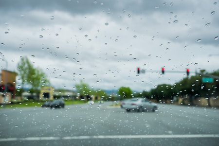 Raindrops on the windshield while driving on a rainy day, California