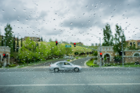 Raindrops on the windshield while driving on a rainy day, Californiaの写真素材