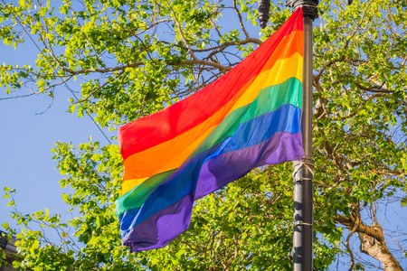 Rainbow flag blowing in the wind, LGBTQ pride month, San Francisco, Californiaの写真素材