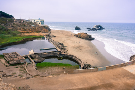 Ruins of the Sutro baths on a cloudy day; the Cliff house in the background, Lands End, San Francisco, Californiaの写真素材