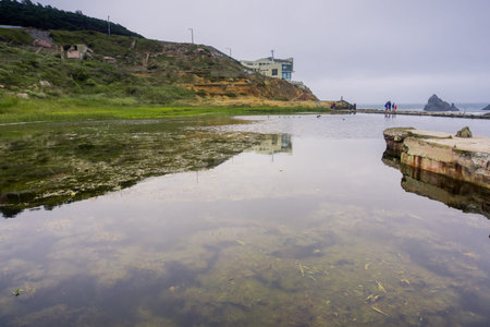 Ruins of the Sutro baths on a cloudy day; the Cliff house in the background, Lands End, San Francisco, Californiaの写真素材