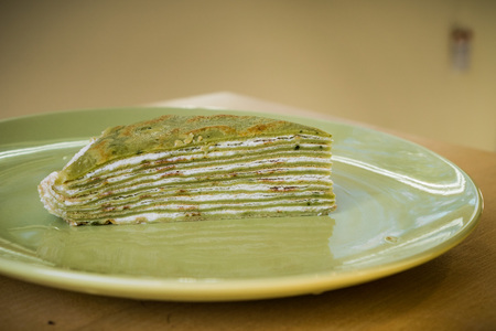 Slice of homemade Matcha mille crepe cakeの写真素材