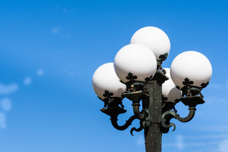 Vintage street lights on a blue sky background