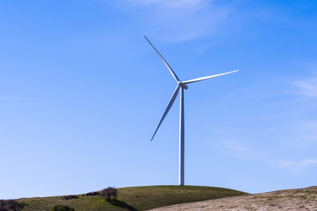 Wind turbines on the top of green hills in east San Francisco bay area on a clear, sunny day, Contra...