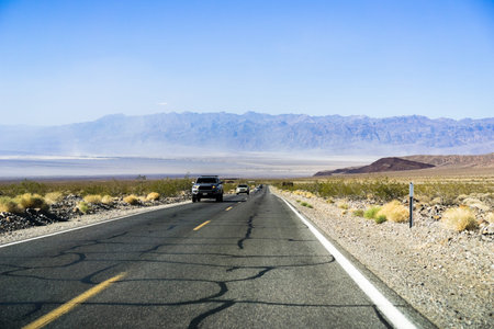 Driving on a long, straight highway through Death Valley National Park, California