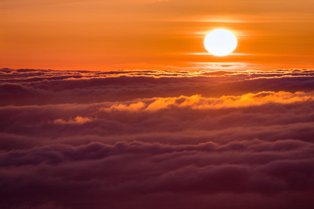 Bright sunlight reflected on a sea of clouds before sunset