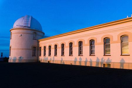 View of the facade of the main building of the historical Lick Observatory (completed in 1888) at sunset; visitors' shadows projected on its walls; San Jose, south San Francisco bay area, Californiaのeditorial素材